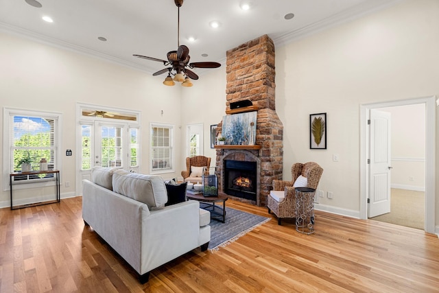 203 Tom Robinson Rd, Franklin, TN 37064 - living room featuring crown molding, a fireplace, a towering ceiling, and a ceiling fan