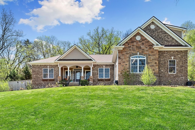 203 Tom Robinson Rd, Franklin, TN 37064 - craftsman-style home with a front yard, a porch, fence, brick siding, and roof with shingles