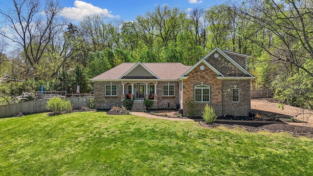 203 Tom Robinson Rd, Franklin, TN 37064 - view of front facade featuring a front yard, fence, brick siding, and a shingled roof
