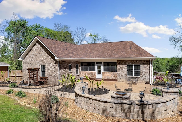 203 Tom Robinson Rd, Franklin, TN 37064 - back of property featuring a patio area, brick siding, fence, and an outdoor fire pit
