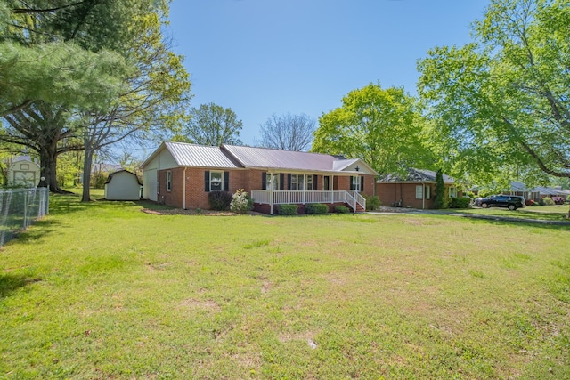 115 Highland Dr, Winchester, TN 37398 - view of front of house featuring brick siding, a front yard, metal roof, and covered porch