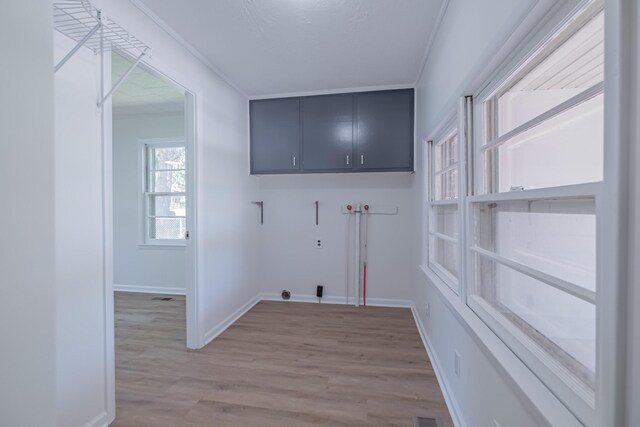 115 Highland Dr, Winchester, TN 37398 - laundry room with cabinet space, crown molding, and light wood finished floors
