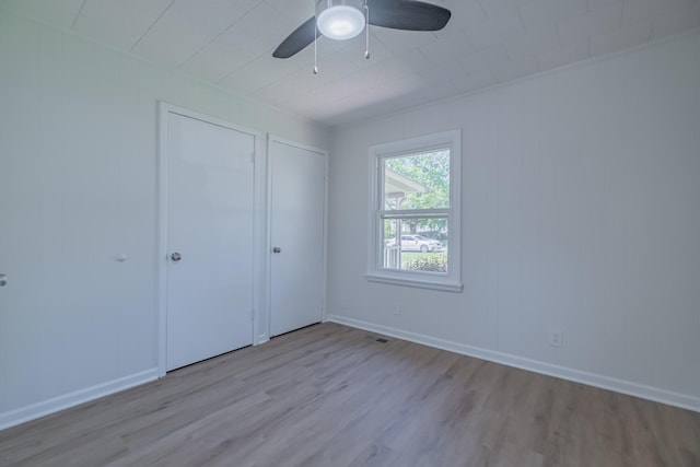 115 Highland Dr, Winchester, TN 37398 - unfurnished bedroom featuring wood finished floors, visible vents, baseboards, and ceiling fan