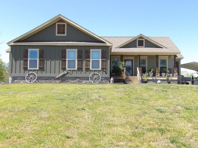 520 Young Rd, Waverly, TN 37185 - view of front facade featuring a porch, board and batten siding, a detached carport, and a front yard