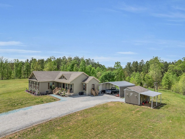 520 Young Rd, Waverly, TN 37185 - view of front of home with gravel driveway, a front lawn, a wooded view, and a detached carport