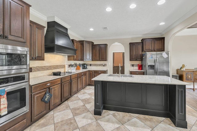 520 Young Rd, Waverly, TN 37185 - kitchen featuring arched walkways, custom exhaust hood, stainless steel appliances, and a sink