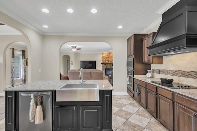 520 Young Rd, Waverly, TN 37185 - kitchen featuring stainless steel appliances, a ceiling fan, a sink, arched walkways, and custom exhaust hood