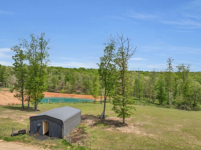 520 Young Rd, Waverly, TN 37185 - view of yard featuring an outdoor structure, an outbuilding, a wooded view, and a water view