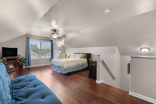bedroom with ceiling fan, baseboards, vaulted ceiling, and dark wood finished floors
