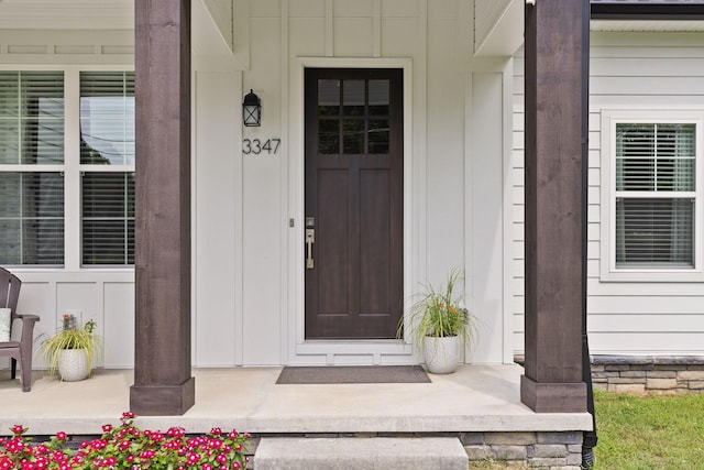 doorway to property featuring board and batten siding