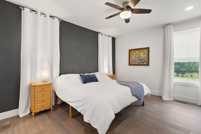 bedroom with a ceiling fan, visible vents, recessed lighting, wood finished floors, and baseboards