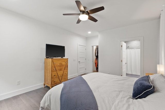 bedroom with ceiling fan, connected bathroom, recessed lighting, wood finished floors, and baseboards