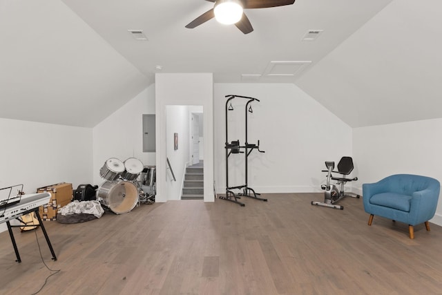 workout room with visible vents, vaulted ceiling, a ceiling fan, and wood finished floors