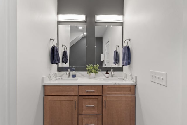 full bathroom featuring a sink and double vanity