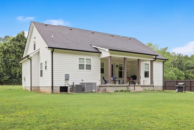 back of house featuring a yard, fence, central AC unit, and a patio