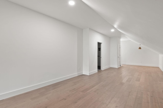 additional living space featuring light wood-type flooring, recessed lighting, baseboards, and lofted ceiling