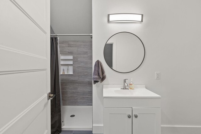 bathroom featuring curtained shower and vanity