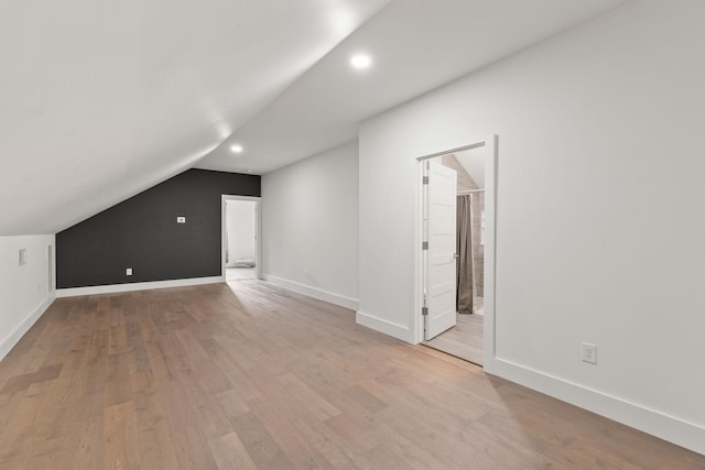 bonus room featuring wood finished floors, baseboards, lofted ceiling, and recessed lighting