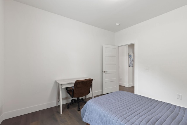 bedroom with baseboards and dark wood-style floors