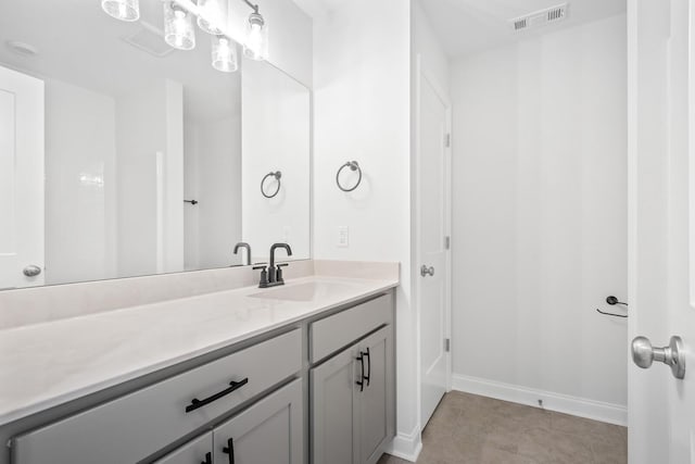 bathroom featuring visible vents, vanity, and baseboards