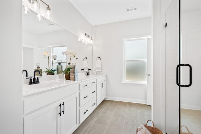 full bathroom featuring visible vents, a wealth of natural light, and a sink