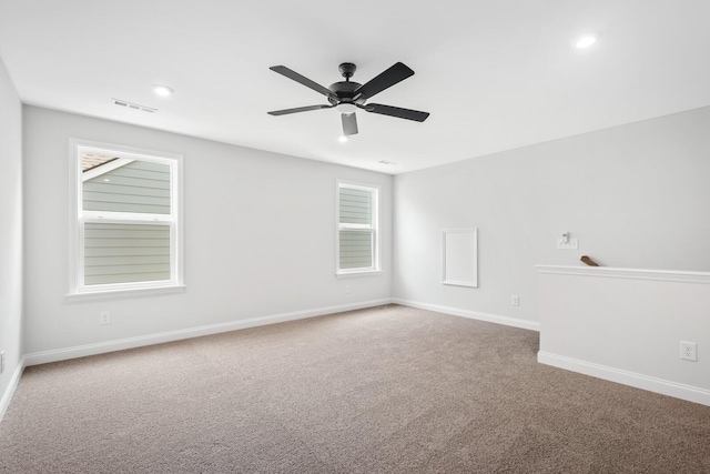 carpeted empty room featuring recessed lighting, visible vents, a ceiling fan, and baseboards