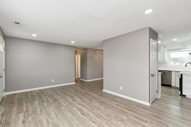 926 Rackley Dr, Pulaski, TN 38478 - unfurnished living room with light wood-style flooring, a sink, baseboards, and recessed lighting