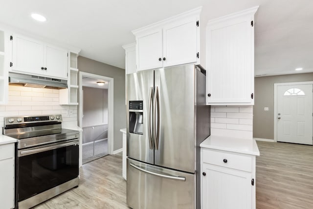 926 Rackley Dr, Pulaski, TN 38478 - kitchen with white cabinets, light countertops, appliances with stainless steel finishes, under cabinet range hood, and light wood-style flooring