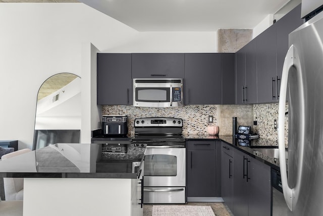kitchen featuring stainless steel appliances, tasteful backsplash, and visible vents
