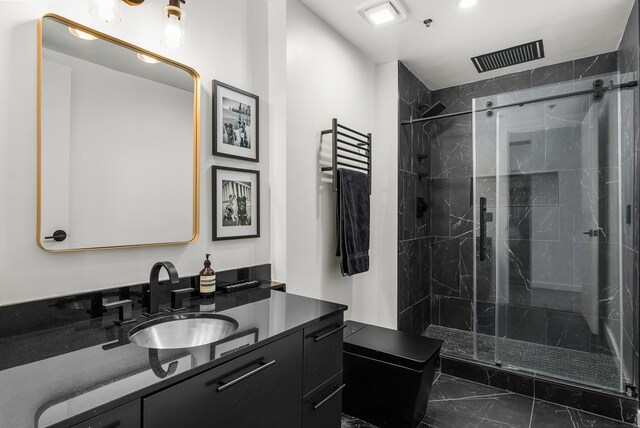 full bath featuring a marble finish shower, visible vents, marble finish floor, and vanity