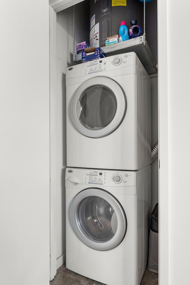laundry room featuring stacked washer / drying machine and laundry area