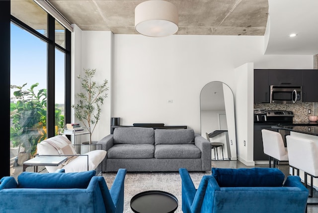living area featuring arched walkways and plenty of natural light