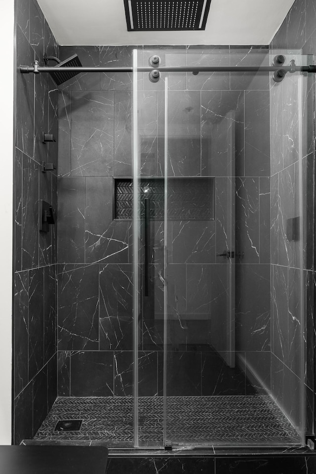 full bathroom with a marble finish shower