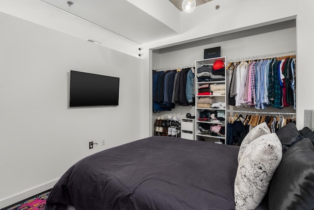bedroom with baseboards and visible vents
