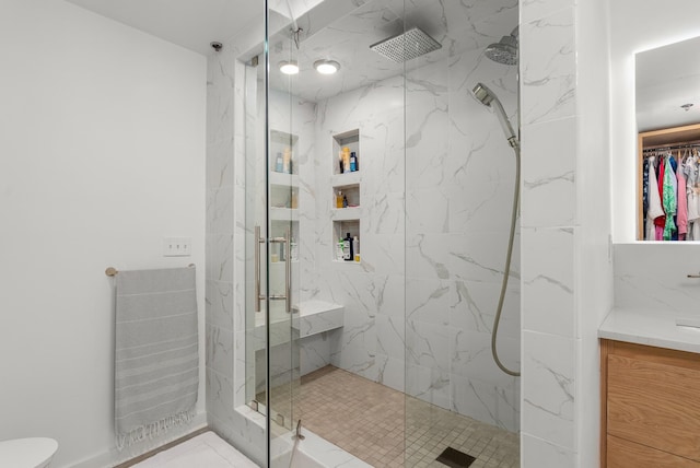 full bath featuring a marble finish shower, toilet, and vanity