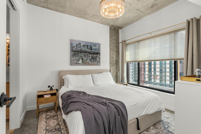 bedroom featuring baseboards and an inviting chandelier