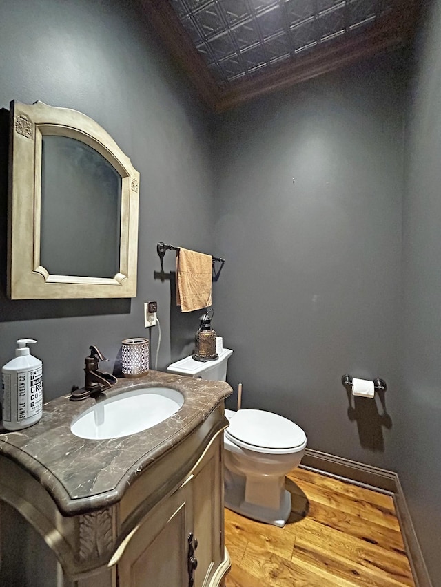 110 Giles Ln, Gallatin, TN 37066 - half bathroom featuring vanity, toilet, wood finished floors, baseboards, and an ornate ceiling