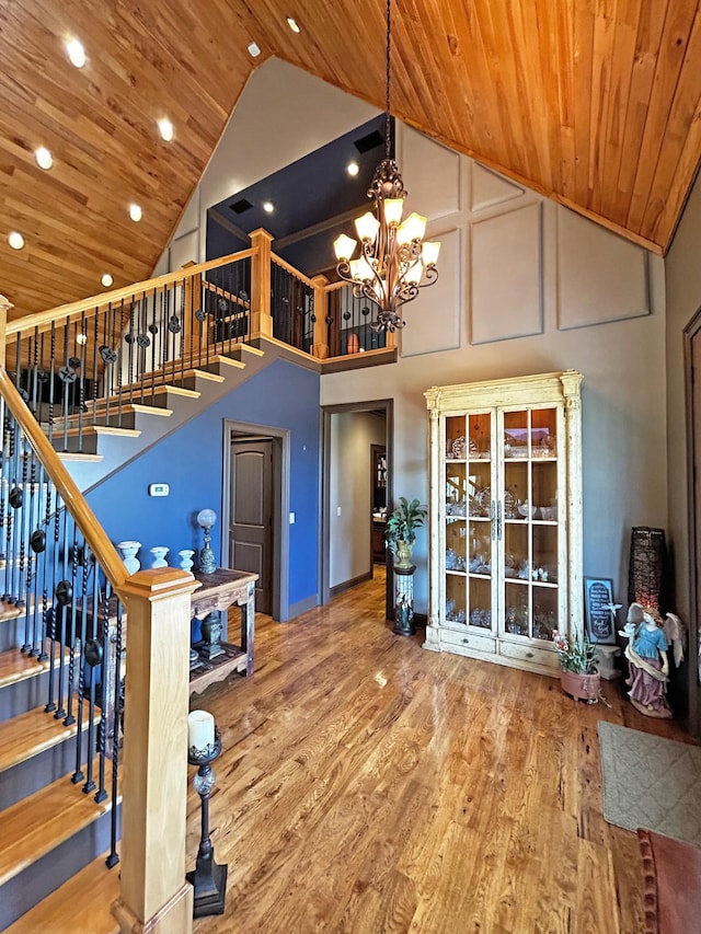 110 Giles Ln, Gallatin, TN 37066 - interior space with wood finished floors, high vaulted ceiling, a notable chandelier, and stairway