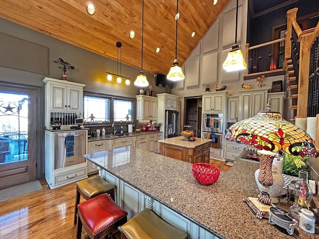 110 Giles Ln, Gallatin, TN 37066 - kitchen featuring light stone counters, black fridge, high vaulted ceiling, double oven, and wooden ceiling