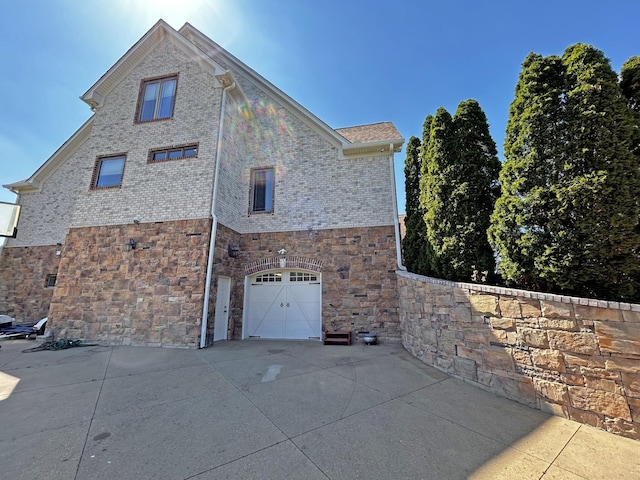 110 Giles Ln, Gallatin, TN 37066 - view of home's exterior featuring brick siding, driveway, stone siding, and an attached garage