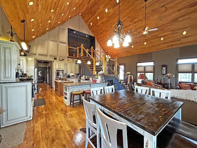 110 Giles Ln, Gallatin, TN 37066 - dining room with a notable chandelier, light wood finished floors, recessed lighting, stairs, and high vaulted ceiling