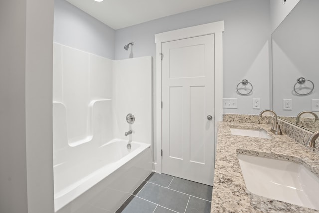full bathroom featuring tile patterned flooring, double vanity, a sink, and shower / washtub combination