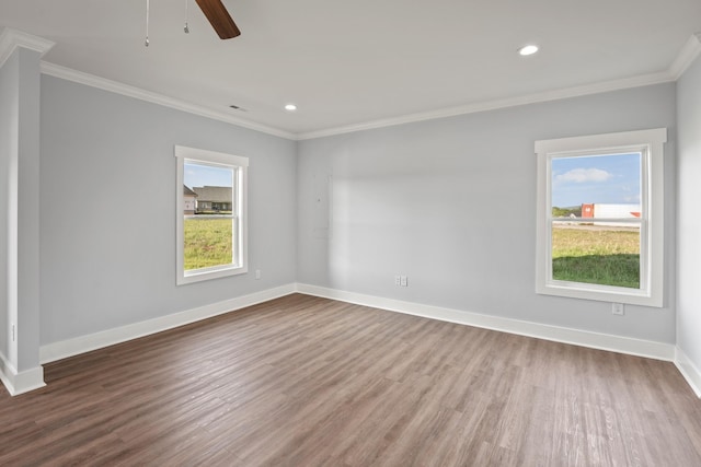 unfurnished room with wood finished floors, baseboards, ornamental molding, and recessed lighting