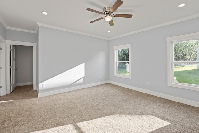 empty room featuring recessed lighting, plenty of natural light, baseboards, and crown molding