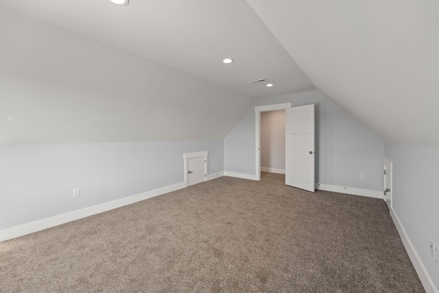 additional living space featuring visible vents, baseboards, carpet, recessed lighting, and vaulted ceiling