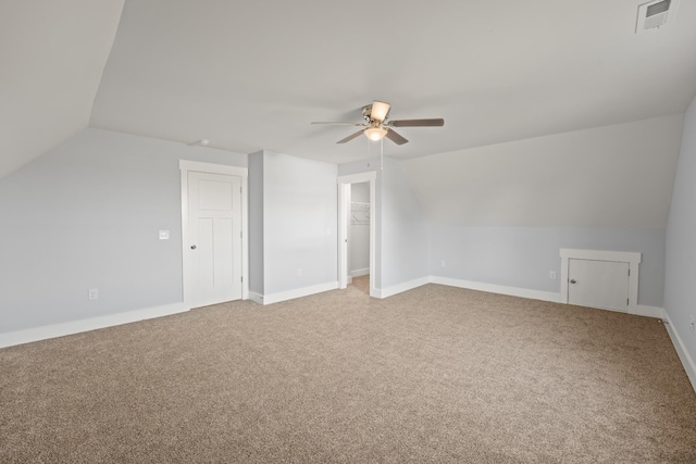 additional living space featuring light carpet, ceiling fan, lofted ceiling, and visible vents