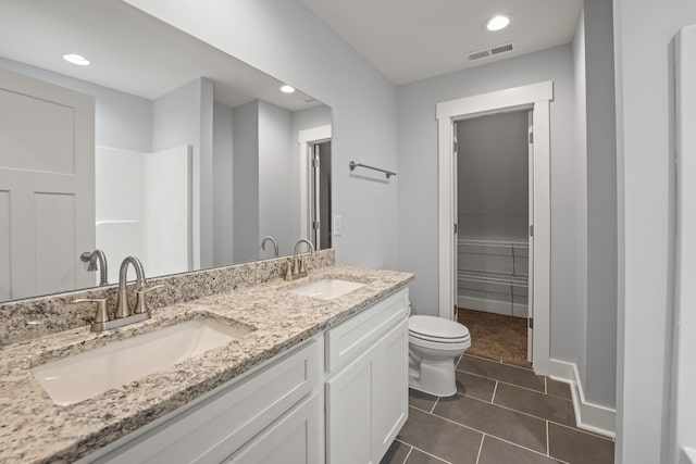 bathroom with toilet, a sink, tile patterned flooring, and visible vents