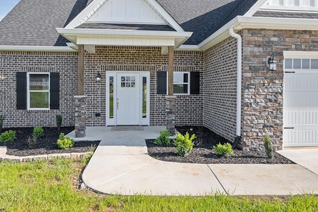 property entrance featuring brick siding and a shingled roof