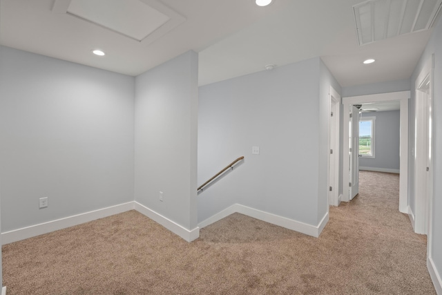 interior space featuring visible vents, baseboards, recessed lighting, and light colored carpet