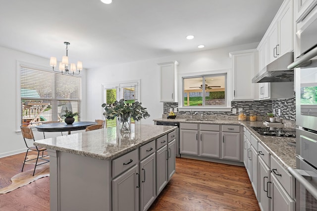 kitchen featuring gray cabinets, tasteful backsplash, gas cooktop, and a wealth of natural light